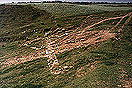 [image ALT: A straight line of stones on a barren hill was once the front of a Roman theater stage, but it definitely takes imagination.]